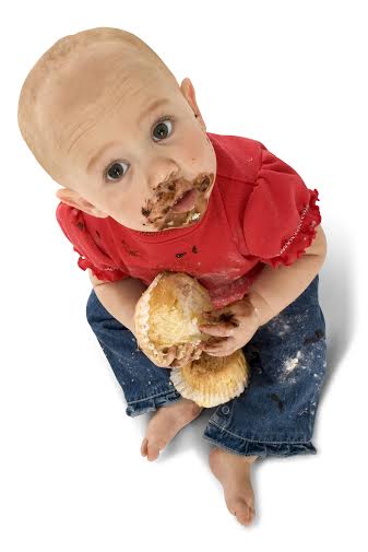Baby with face covered in chocolate.  Clipping path.  Full body over white.